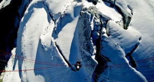 Birds eye view of paraglider flying over the Petit Combin glacier Switzerland